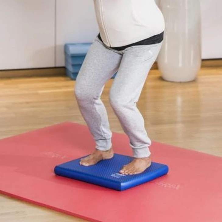 Person using a balance pad for hiking training.