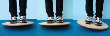 A man standing on a wobble balance board