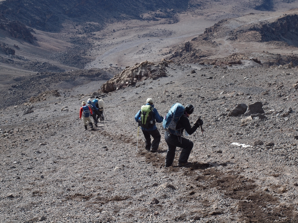 Jane S hiking downhill from Mount Kilimanjaro.