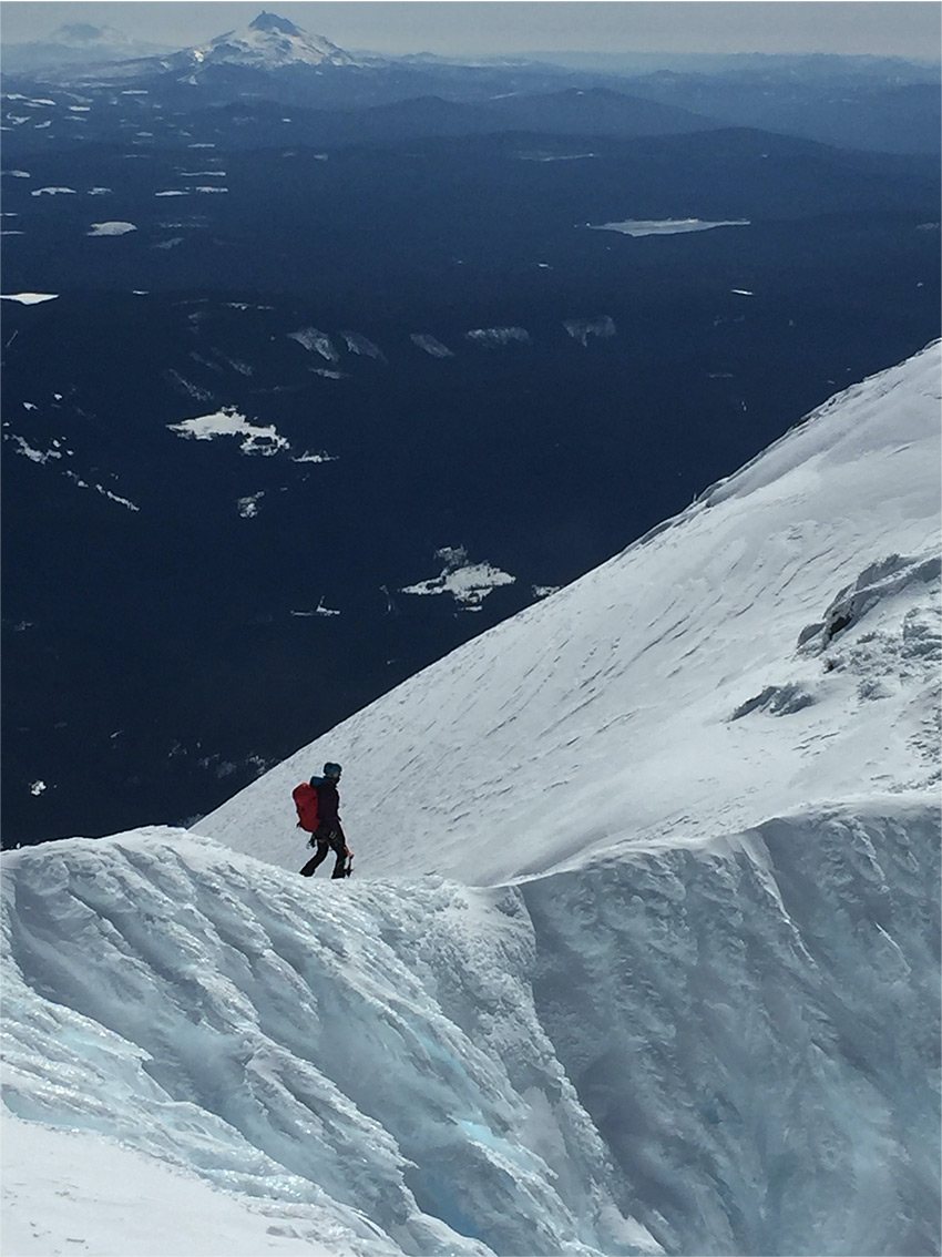 Climber on the Wy'east Route, heading down Mt Hood on East Crater Rim.