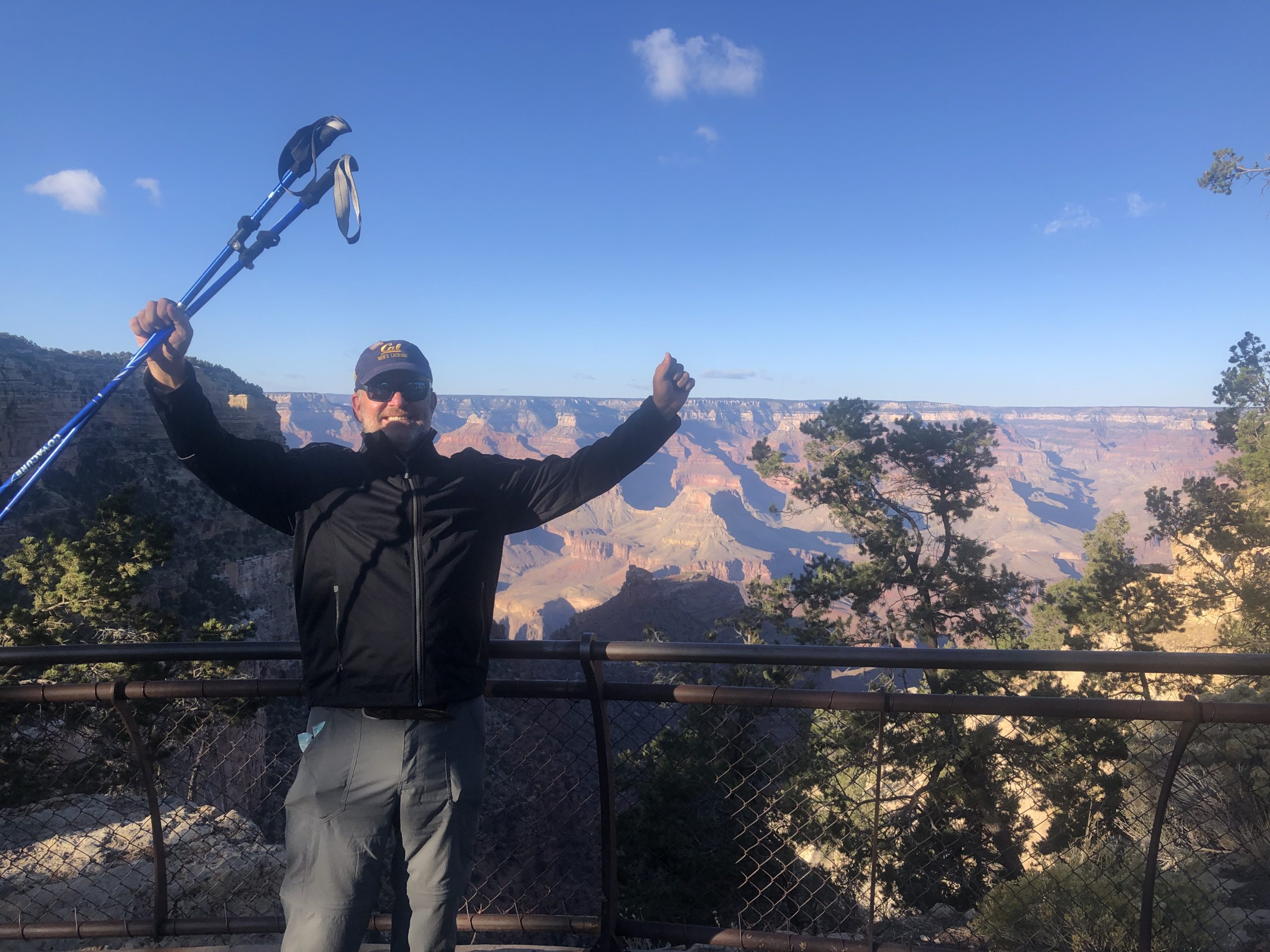 On south rim after successful rim to rim grand canyon with hiking poles and hiking backpack.