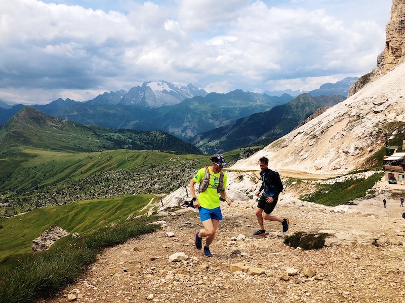 Two trail runners on a trail in the Dolomites.
