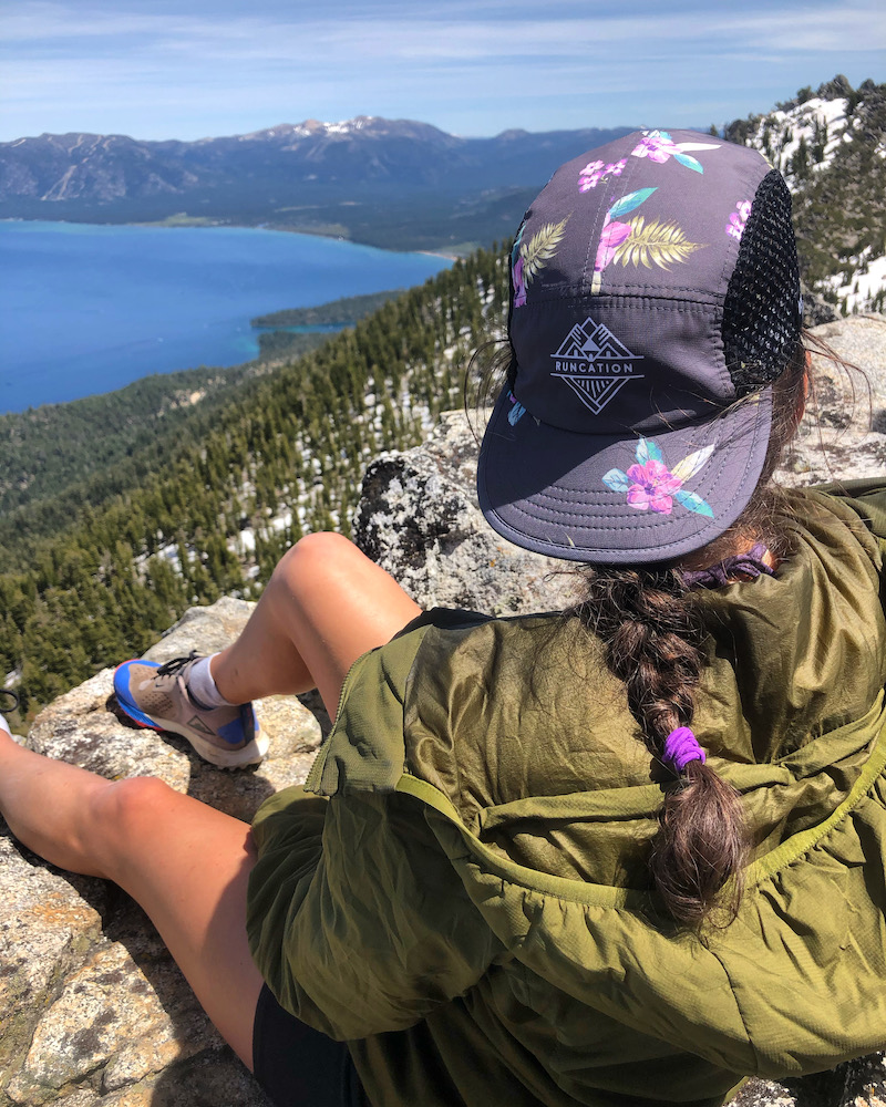 Female trail runner sitting on trail in Lake Tahoe.