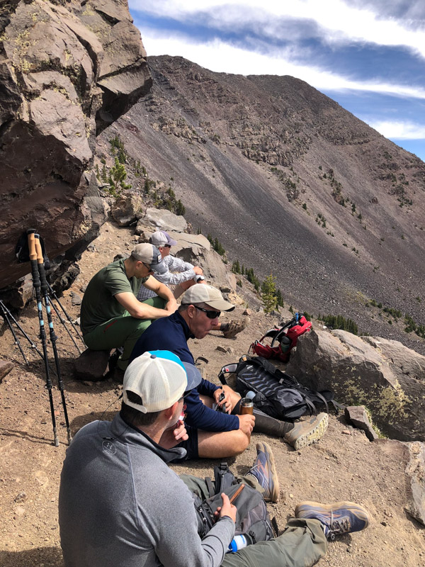 Hikers eating snacks and resting at the saddle before Humphreys Peak.