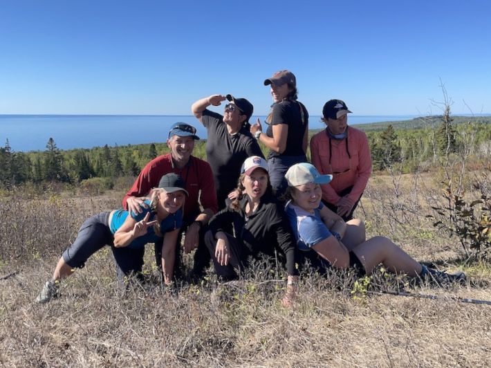 Group of hikers on Wildflower Hill with Lake Superior in the back.