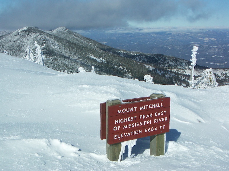 Mount Mitchell sign with snow in winter.